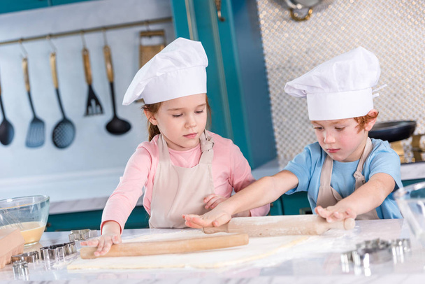 cute little kids preparing dough for cookies in kitchen - 写真・画像