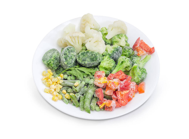 Diferentes verduras congeladas en el primer plato blanco
 - Foto, Imagen