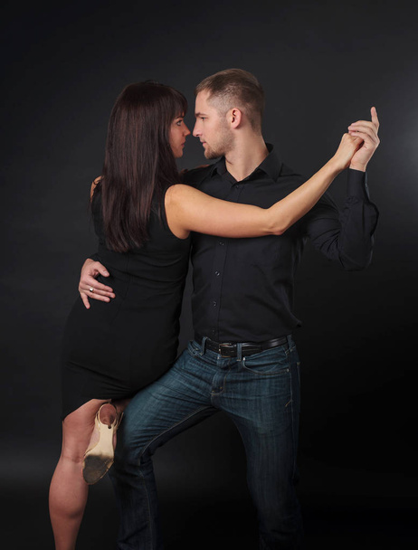 Couple dancing on a black background. - Foto, imagen