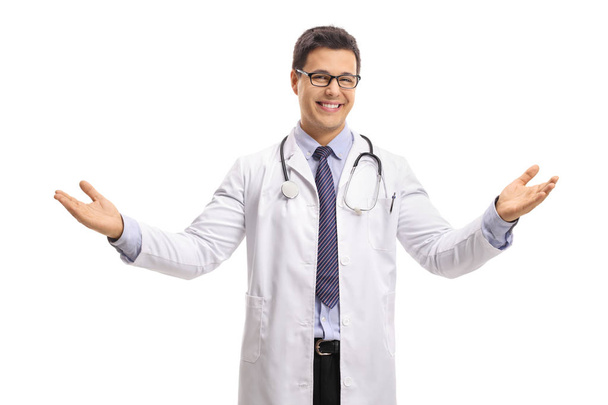 Doctor making a welcome gesture and smiling isolated on white background - Fotó, kép
