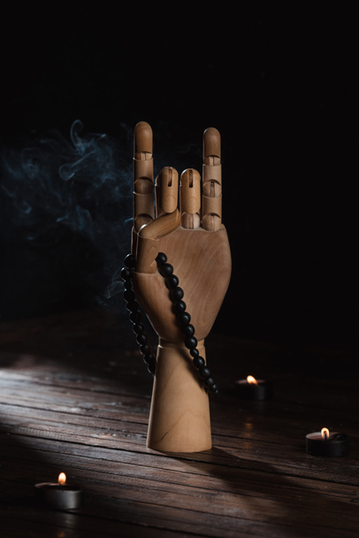 wooden hand with apan mudra gesture and rosary - Photo, image