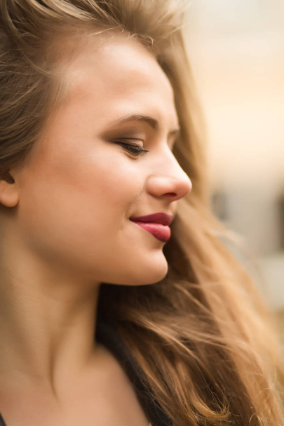 Closeup shot of beautiful young woman with red lips and lush blo - Фото, зображення