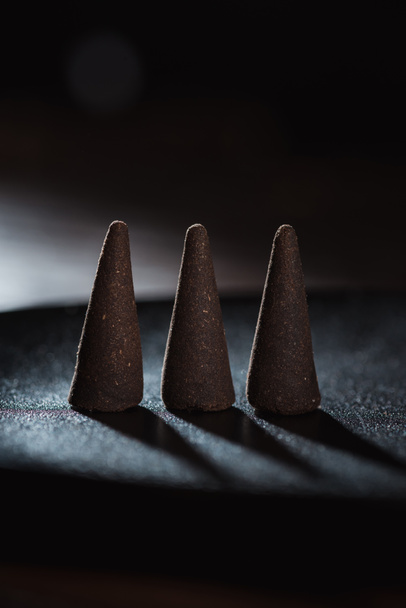 three incense sticks on dark surface - Photo, image