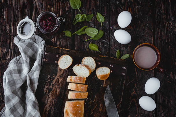 close-up of fresh homemade bread with eggs on rustic wooden background  - Foto, immagini