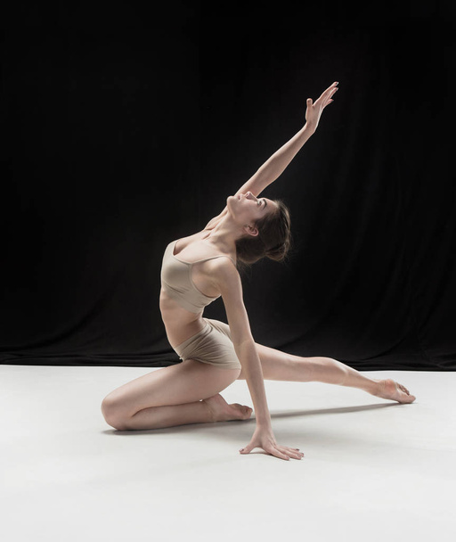 Young teen dancer on white floor background. - Photo, Image