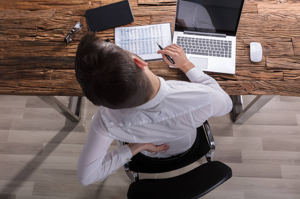 High Angle View Of A Businessman Suffering From Back Pain In Office - Photo, image