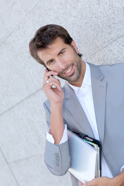 Portrait of salesman talking on mobile phone - Fotó, kép