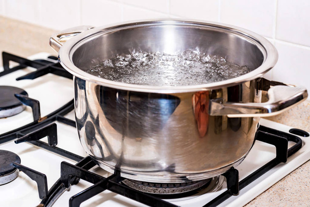 Boiling water for soup in modern saucepan - Foto, Imagen