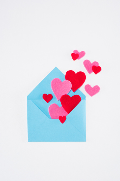 top view of blue envelope with colored hearts isolated on white, valentines day concept - Фото, зображення