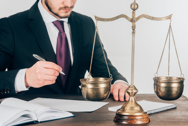 cropped shot of lawyer doing paperwork at workplace with scales - Photo, Image