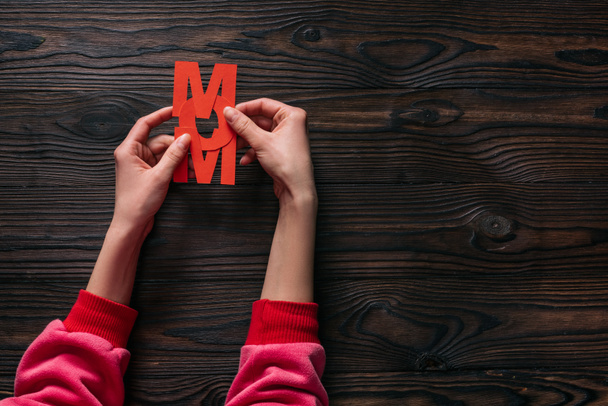 cropped shot of woman holding mom lettering in hands - Photo, Image