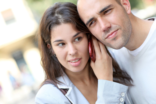 Portrait of young couple in town with smartphone - Photo, image