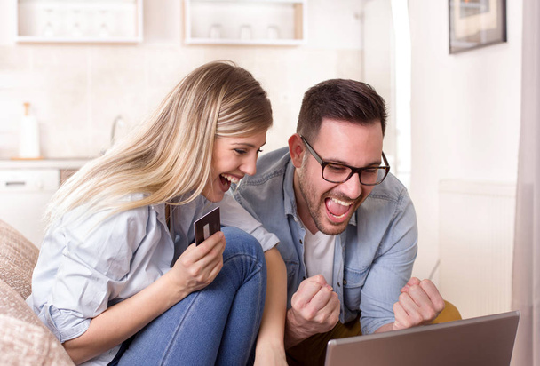 Young couple shopping online at home - Photo, Image