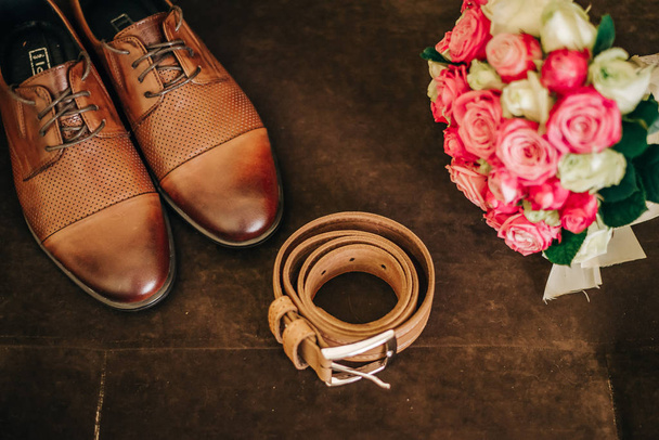 brown groom shoes with a belt and a bouquet of flowers - Photo, Image