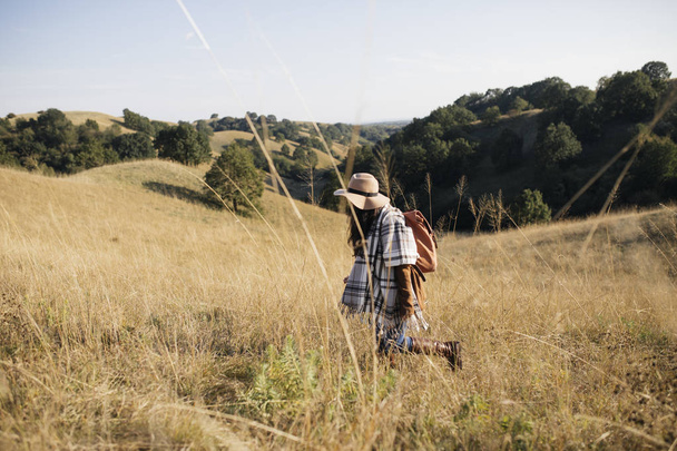 Woman Hiking in Field - 写真・画像