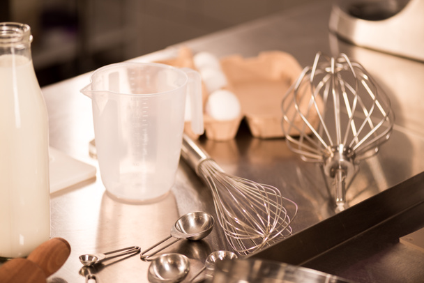 close up view of ingredients for dough and kitchen utensils on counter in restaurant - Fotografie, Obrázek