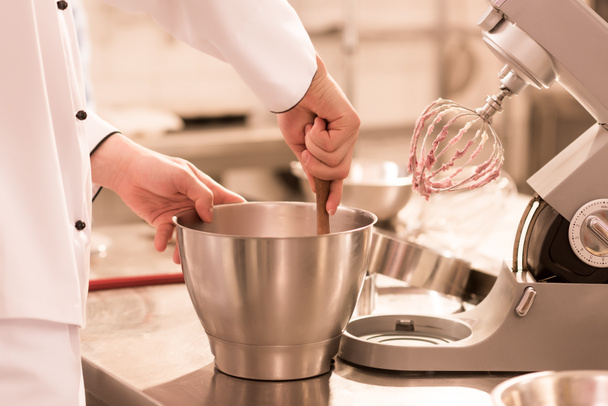 partial view of confectioner making cream for dessert in restaurant kitchen - Photo, Image