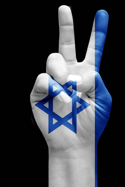 and making victory sign, Israe painted with flag as symbol of victory, win, success - isolated on black background - Fotó, kép