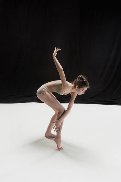 Young teen dancer on white floor background. - Valokuva, kuva