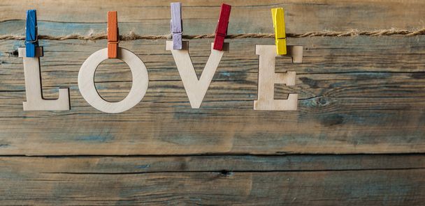 woorden van liefde hangen met touw hout achtergrond (de dag van Valentijnskaarten) - Foto, afbeelding