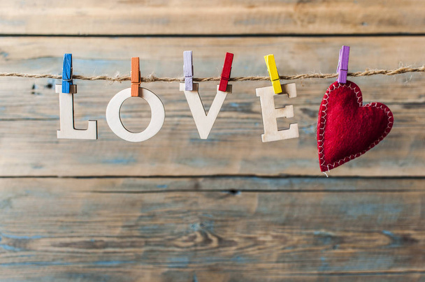words Love hang with rope on wood background (Valentines day) - Photo, image