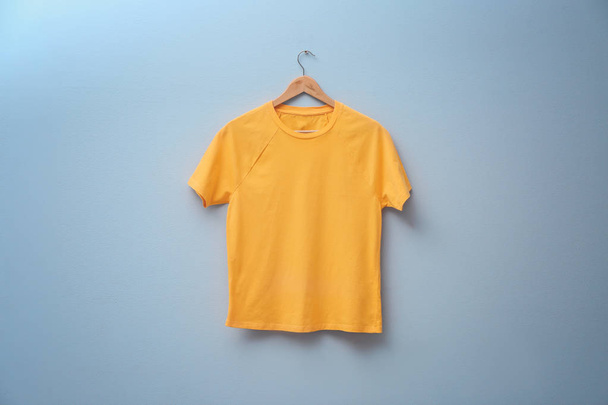 Yellow t-shirt on color background. Mock up for design - Foto, afbeelding