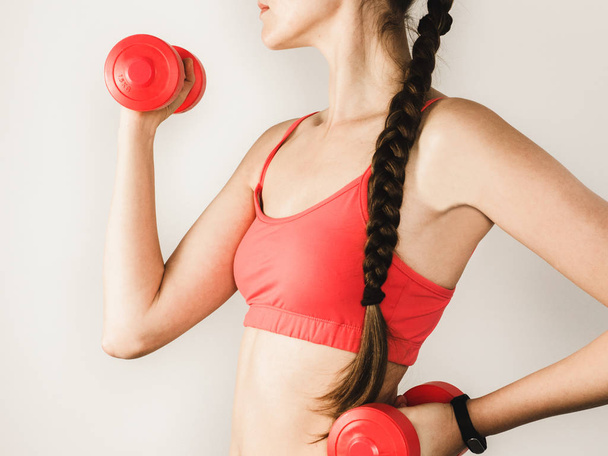 Stylish woman during exercises with dumbbells - Φωτογραφία, εικόνα