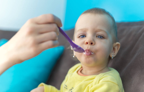 Alimentar a su bebé con una cuchara
 - Foto, Imagen