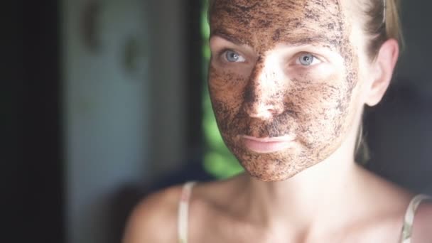 Closeup face of woman with facial coffee mask - video in slow motion - Footage, Video