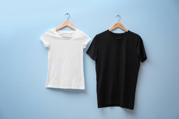 White and black t-shirts on color background. Mock up for design - Fotografie, Obrázek