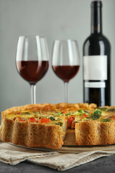 Tasty broccoli quiche served with wine on table - Photo, Image