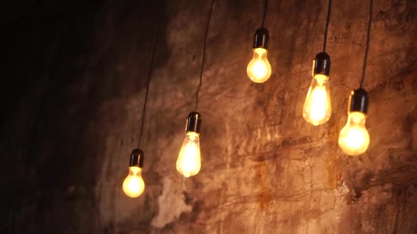 a close shot at the bright Edison bulbs that hang from above - Footage, Video