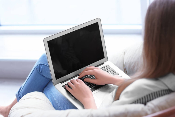 Mulher usando laptop dentro de casa
 - Foto, Imagem