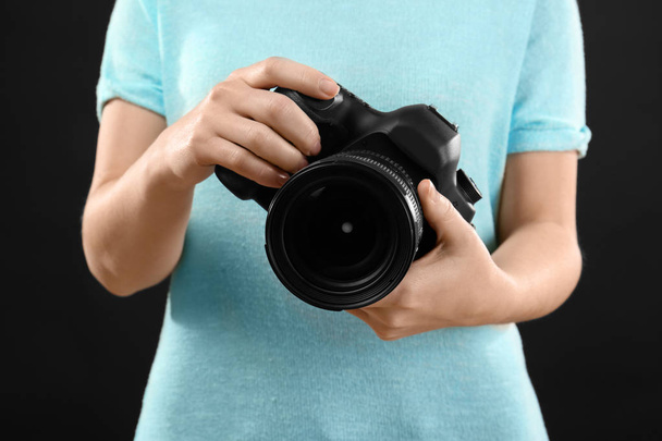 Photographer holding professional camera  - 写真・画像