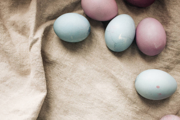 painted Easter eggs on sackcloth, rustic festive composition - Foto, Imagem