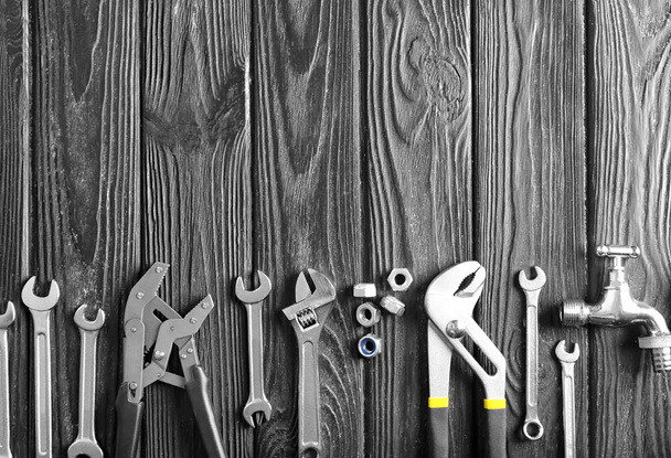 Plumber's tools on wooden background - Foto, afbeelding