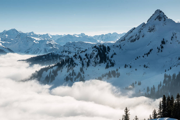 Snow on the top of the mountains and fog down the valley - Foto, afbeelding