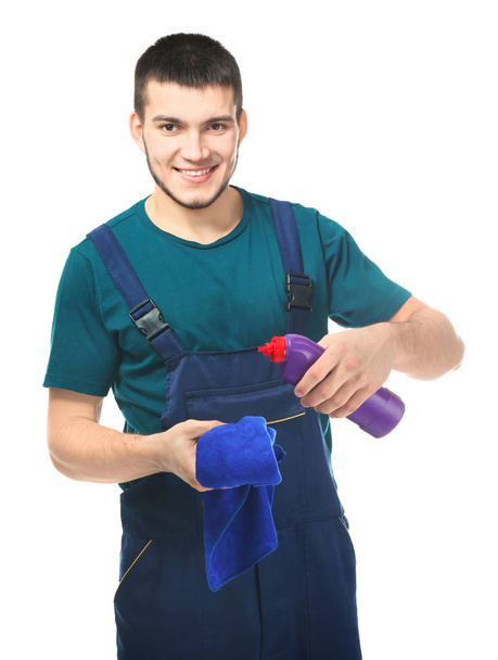Young man with cleaning supplies on white background - Fotoğraf, Görsel