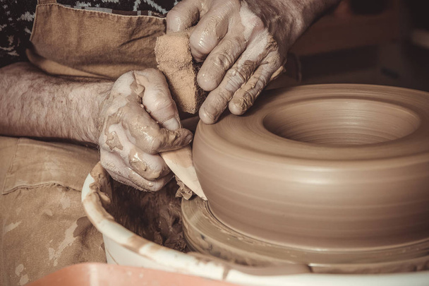 elderly man making pot using pottery wheel in studio - Zdjęcie, obraz