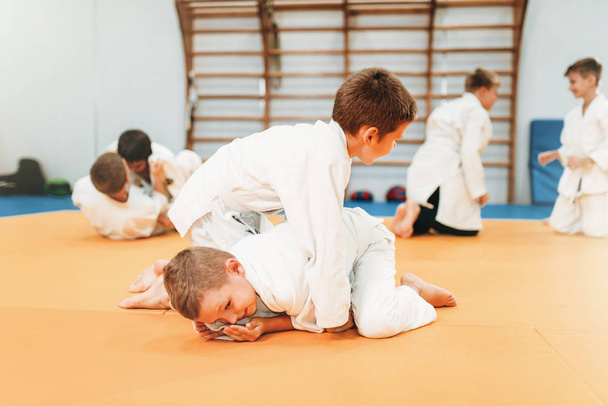  boys in kimono practicing martial art in sport gym  - Photo, Image