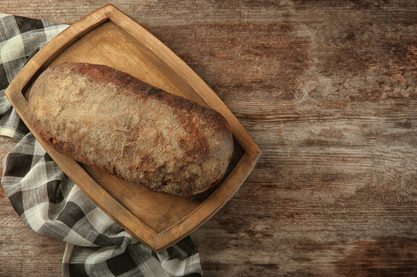 Loaf of rye bread on table. Fresh from oven - Fotografie, Obrázek