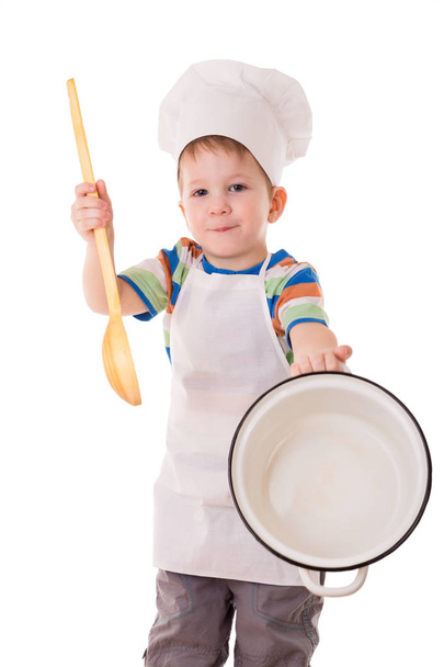 Little cook showing empty white pan - Φωτογραφία, εικόνα