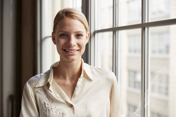 Young blonde businesswoman smiling to camera - Photo, Image