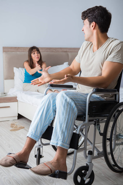 Wanhopige man op rolstoel met zijn trieste vrouw - Foto, afbeelding