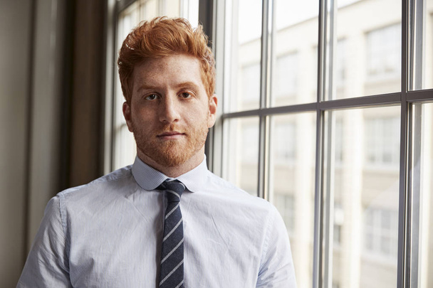 Young red haired bearded businessman looking to camera - Foto, Imagen