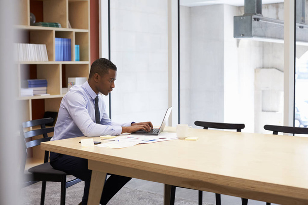 Young black businessman working alone in an office - Фото, зображення