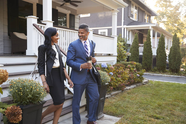 Business Couple Leaving Suburban House For Commute To Work - Photo, image
