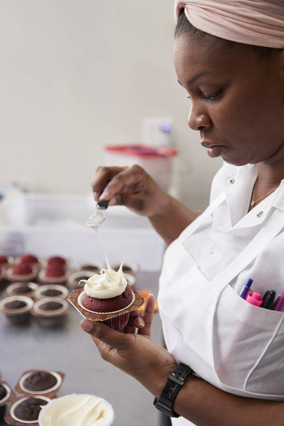 Young black woman preparing food in a bakery, close up - 写真・画像