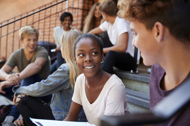 Group Of Teenage Students Socialising On College Campus Together - Φωτογραφία, εικόνα