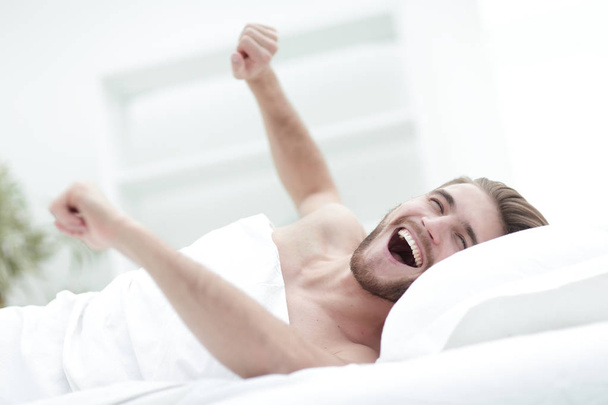 happy man waking up in a comfortable room - Foto, imagen